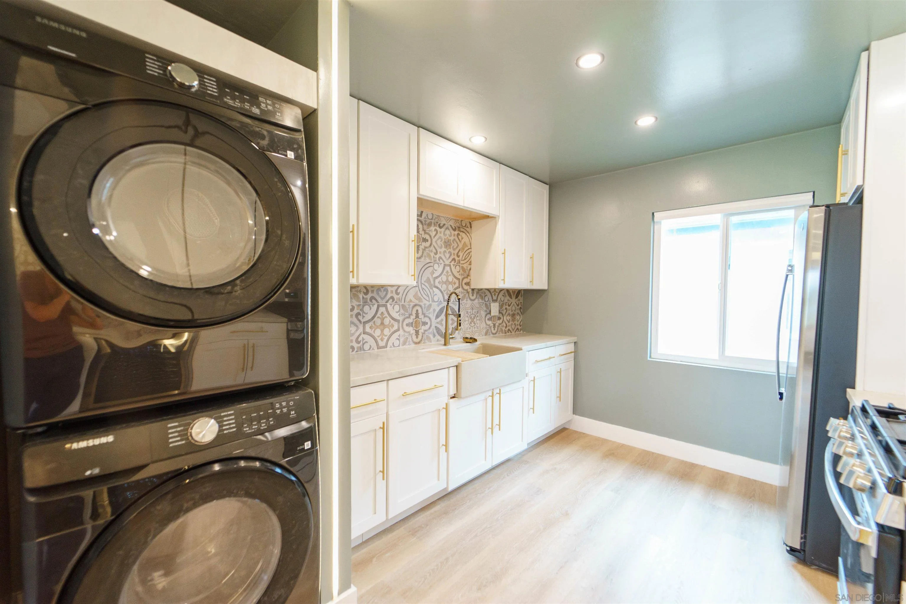 4518-24 Kansas Street San Diego, CA 92116 - Photo 17 of 33 a view of a bathroom with washing machine and mirror