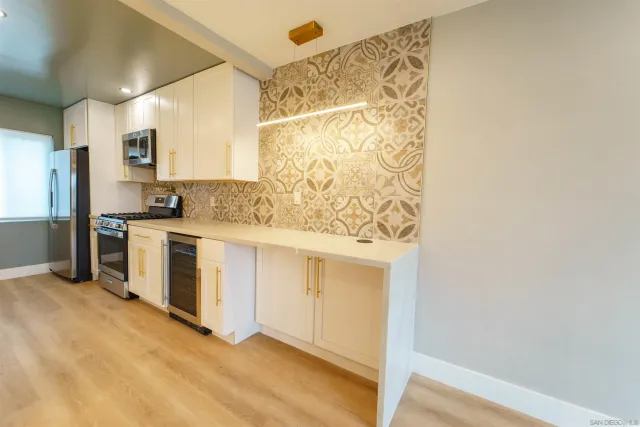 a view of a bathroom with washing machine and mirror
