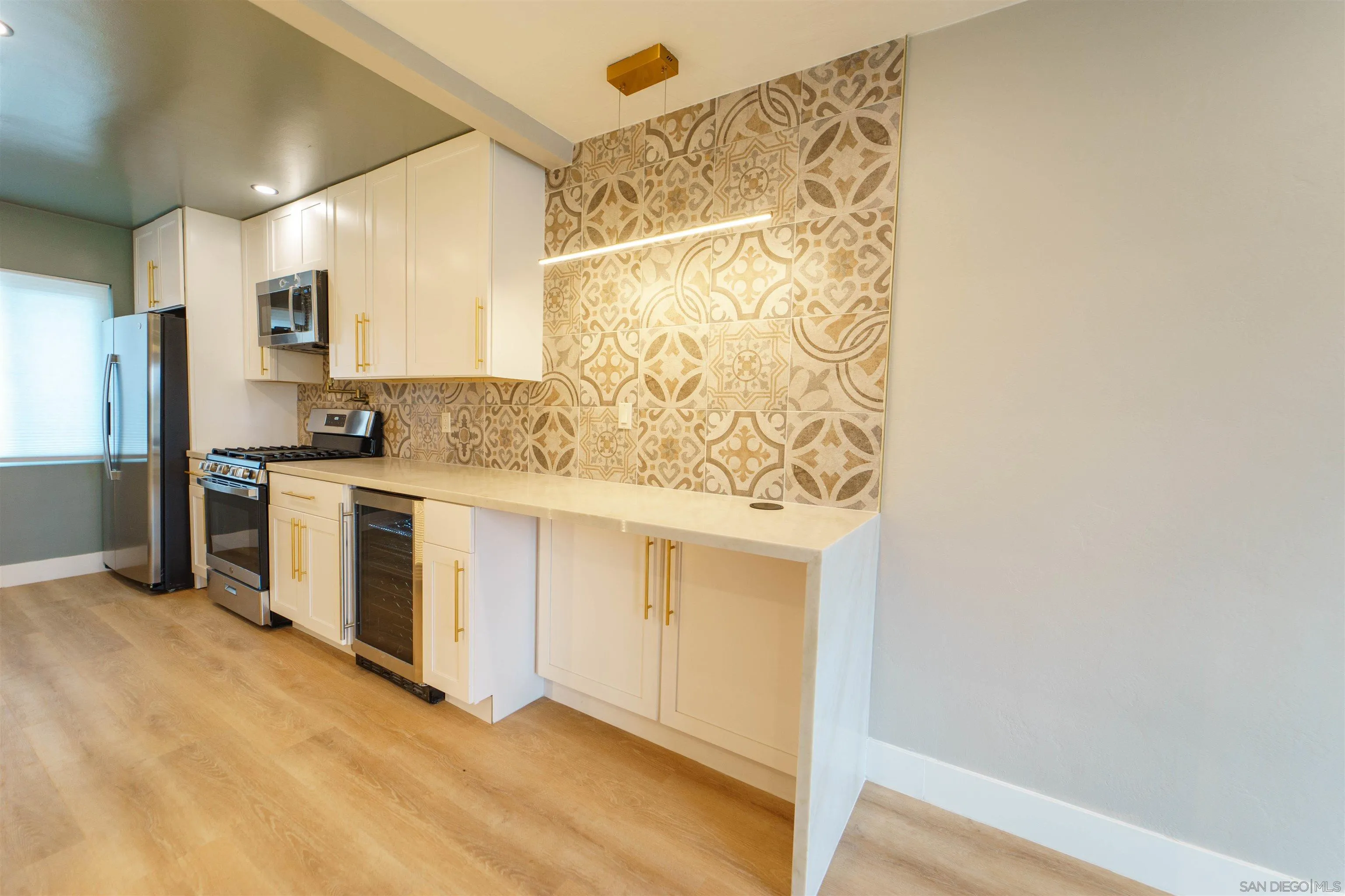 4518-24 Kansas Street San Diego, CA 92116 - Photo 21 of 33 a kitchen with stainless steel appliances a stove a sink and a refrigerator