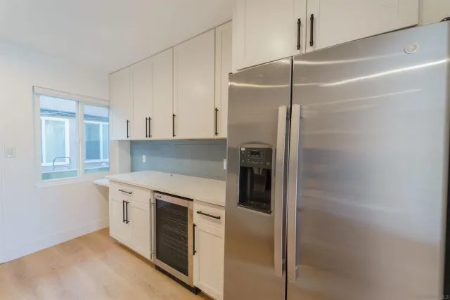 a view of a kitchen with sink and dishwasher with wooden floor