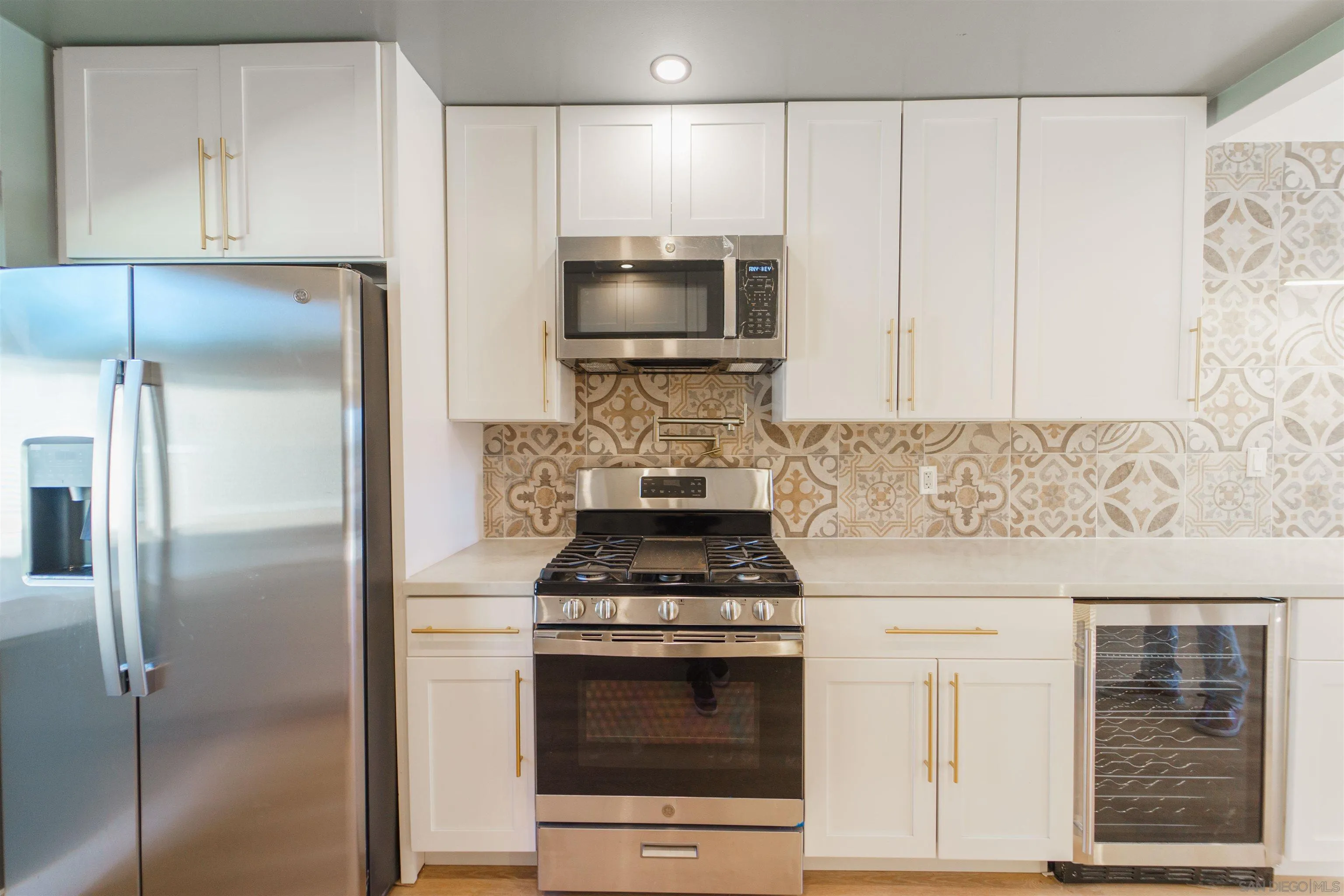 4518-24 Kansas Street San Diego, CA 92116 - Photo 27 of 33 a kitchen with stainless steel appliances granite countertop a stove and a refrigerator