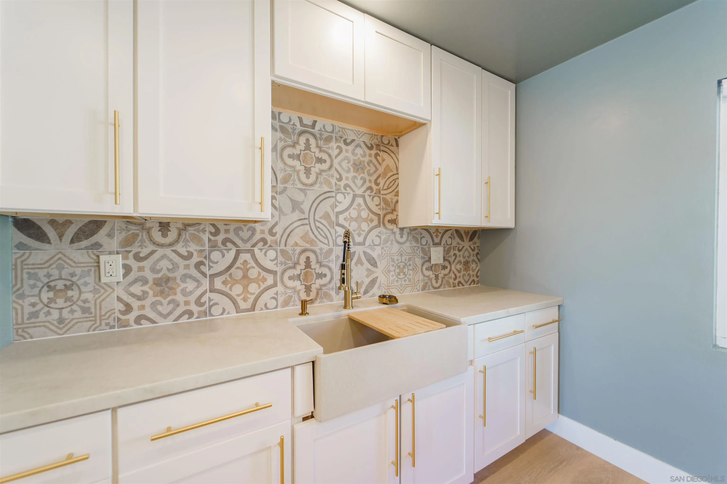 4518-24 Kansas Street San Diego, CA 92116 - Photo 28 of 33 a view of a kitchen with sink and dishwasher with wooden floor