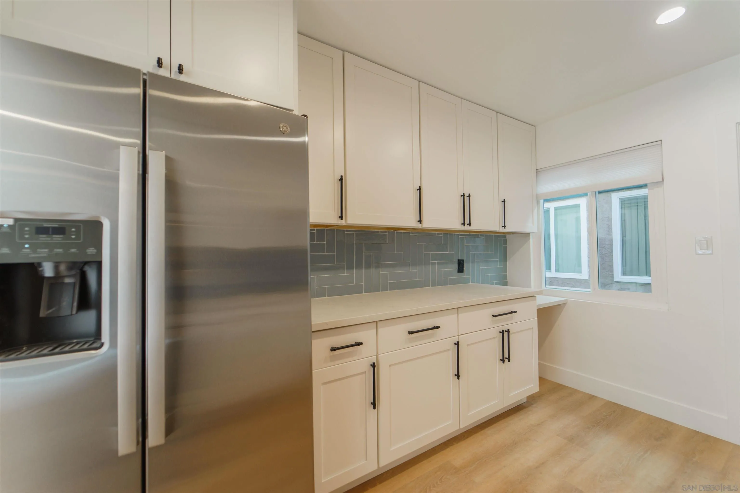 4518-24 Kansas Street San Diego, CA 92116 - Photo 30 of 33 a kitchen with white cabinets and window