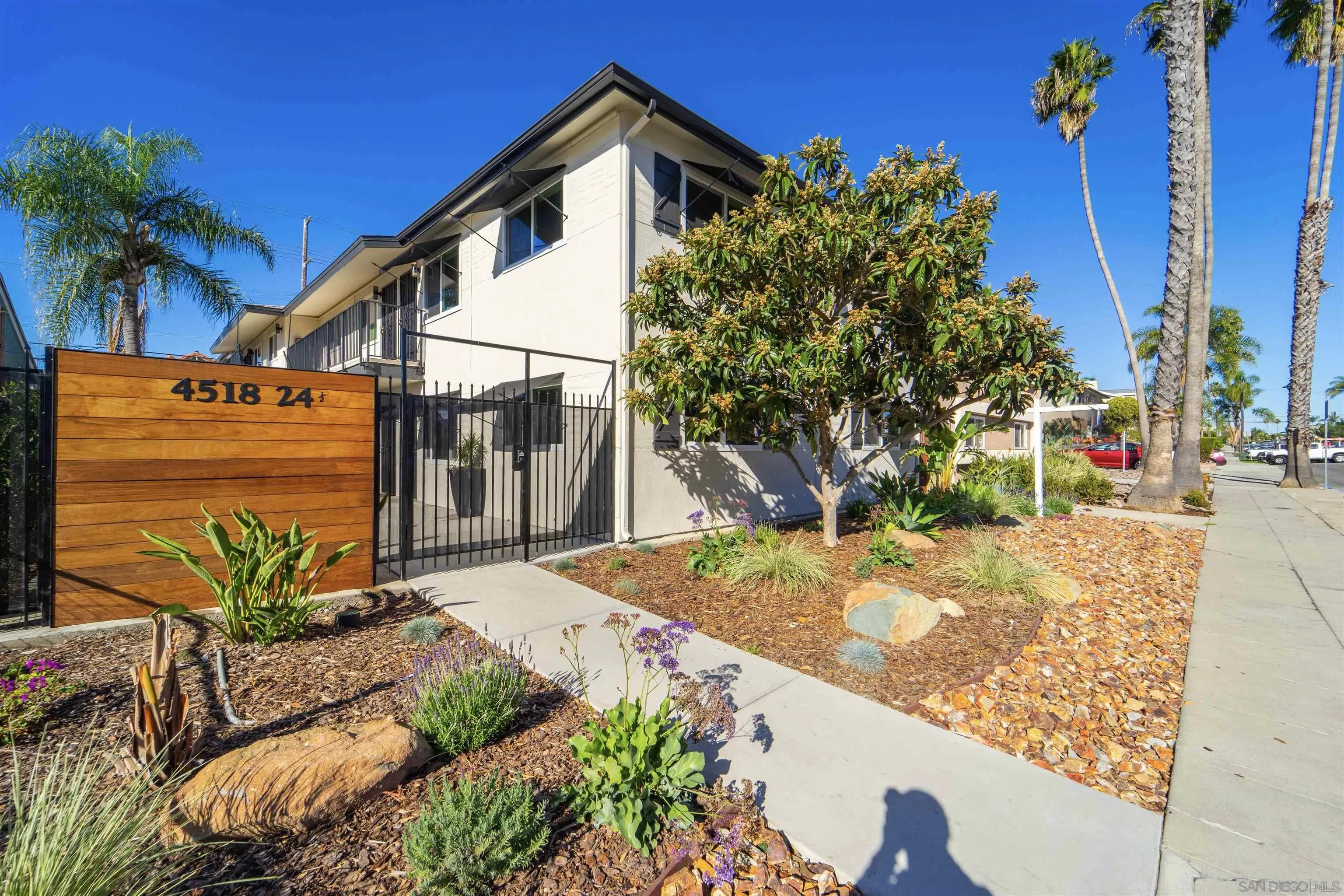 4518-24 Kansas Street San Diego, CA 92116 - Photo 3 of 33 a view of a house with a small yard and potted plants