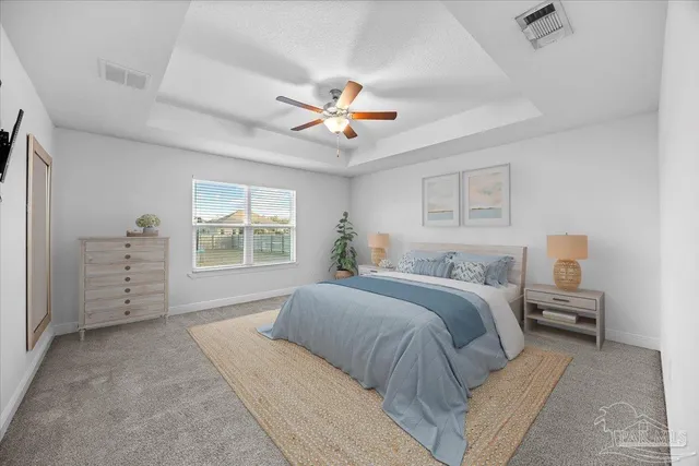a spacious bedroom with a bed a dresser and a chandelier