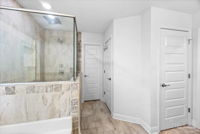 a bathroom with a glass shower door