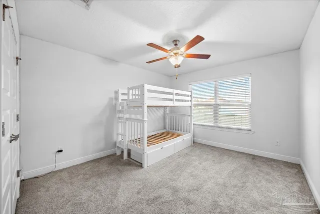 a living room with furniture and a ceiling fan