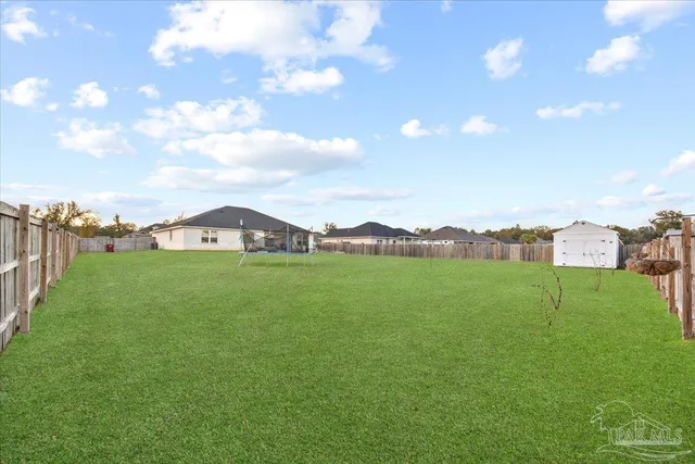 a view of a green field with mountains in the background
