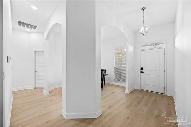 a view of a room with wooden floor and white walls