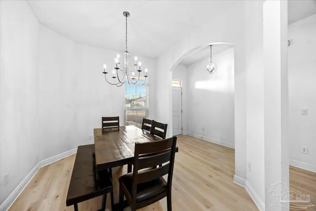 a view of a dining room with furniture and chandelier