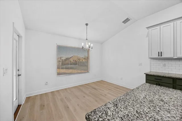 a room with a bed and a chandelier