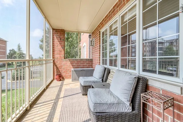 a balcony with furniture and wooden floor