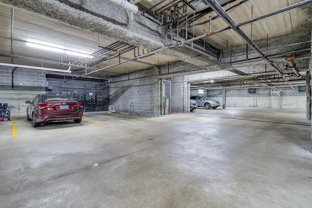 a view of parking garage with cars