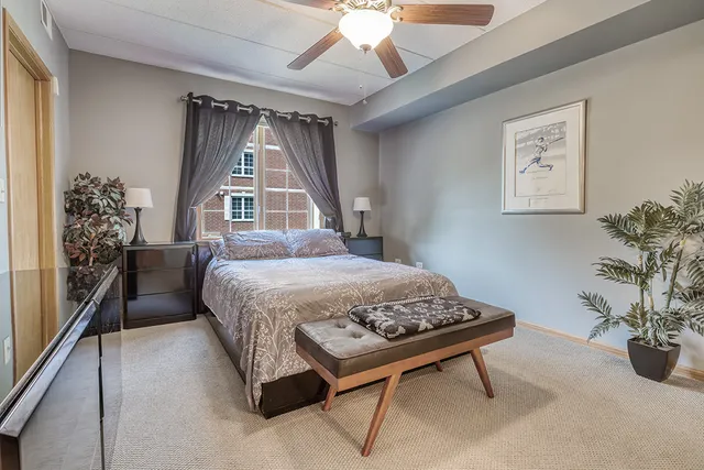 a spacious bedroom with a bed and a chandelier