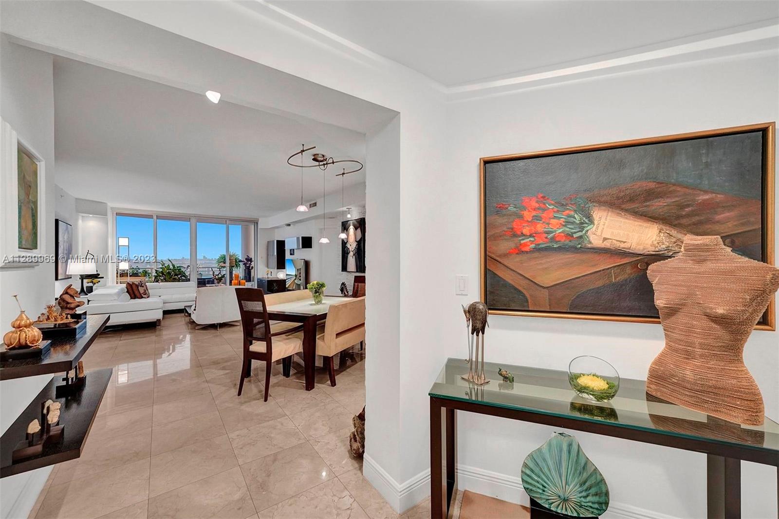 848 Brickell Key Drive, Unit 1602 Miami, FL 33131 - Photo 15 of 33 a living room with furniture and a flat screen tv