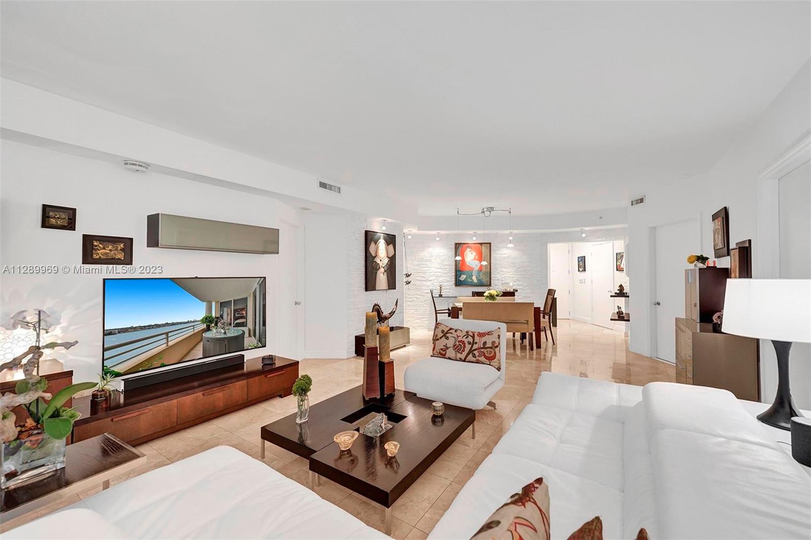 848 Brickell Key Drive, Unit 1602 Miami, FL 33131 - Photo 17 of 33 a living room with furniture a fireplace and a table