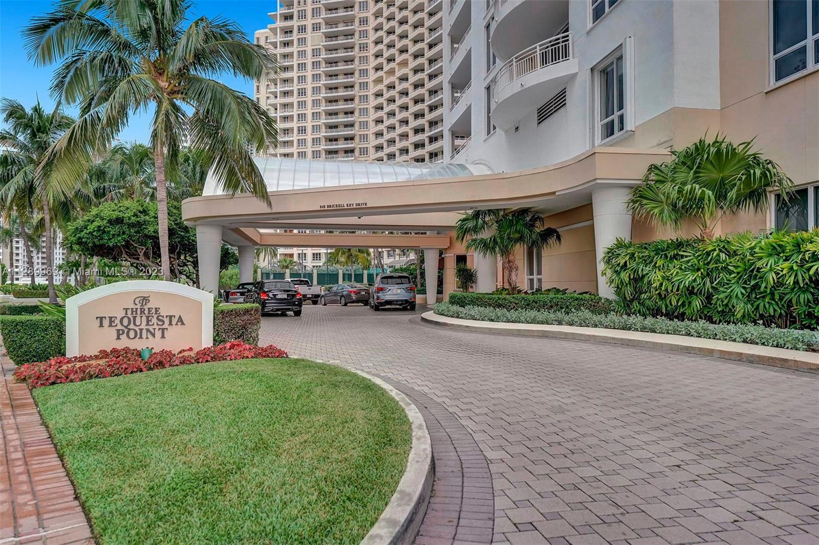 848 Brickell Key Drive, Unit 1602 Miami, FL 33131 - Photo 21 of 33 a front view of a building with a garden and trees