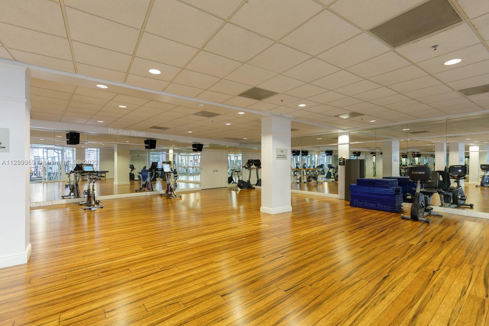 848 Brickell Key Drive, Unit 1602 Miami, FL 33131 - Photo 29 of 33 a swimming pool with lots of furniture and wooden floor