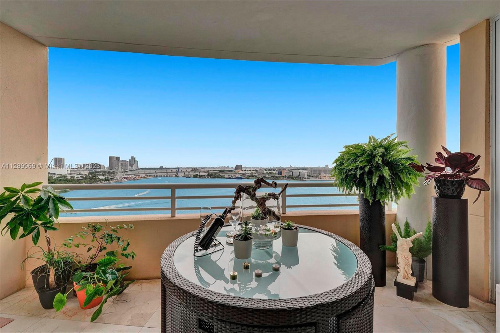 848 Brickell Key Drive, Unit 1602 Miami, FL 33131 - Photo 4 of 33 a terrace with a table and chairs