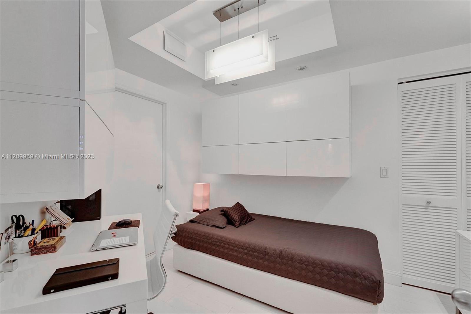 848 Brickell Key Drive, Unit 1602 Miami, FL 33131 - Photo 8 of 33 a bedroom with a bed and a couch