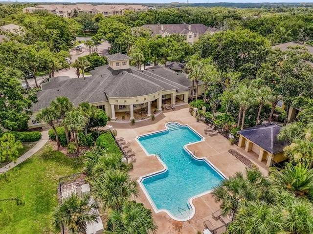 an aerial view of a house with garden space and street view