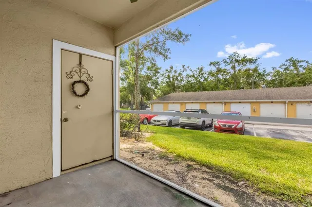 a view of a porch with furniture and a yard