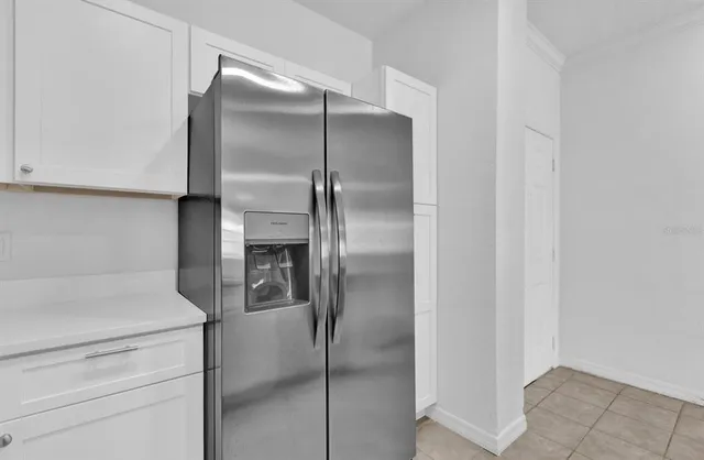 a kitchen with a refrigerator and two washing machine