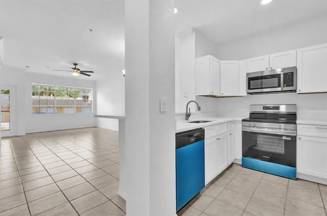 a kitchen with stainless steel appliances granite countertop a refrigerator and a stove top oven