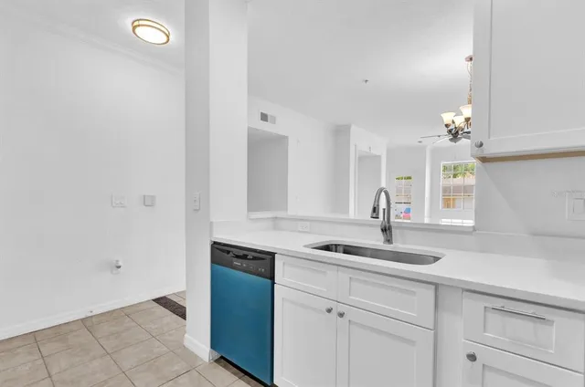 a kitchen with sink and cabinets