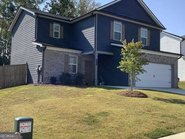 a house that has a tree in front of it