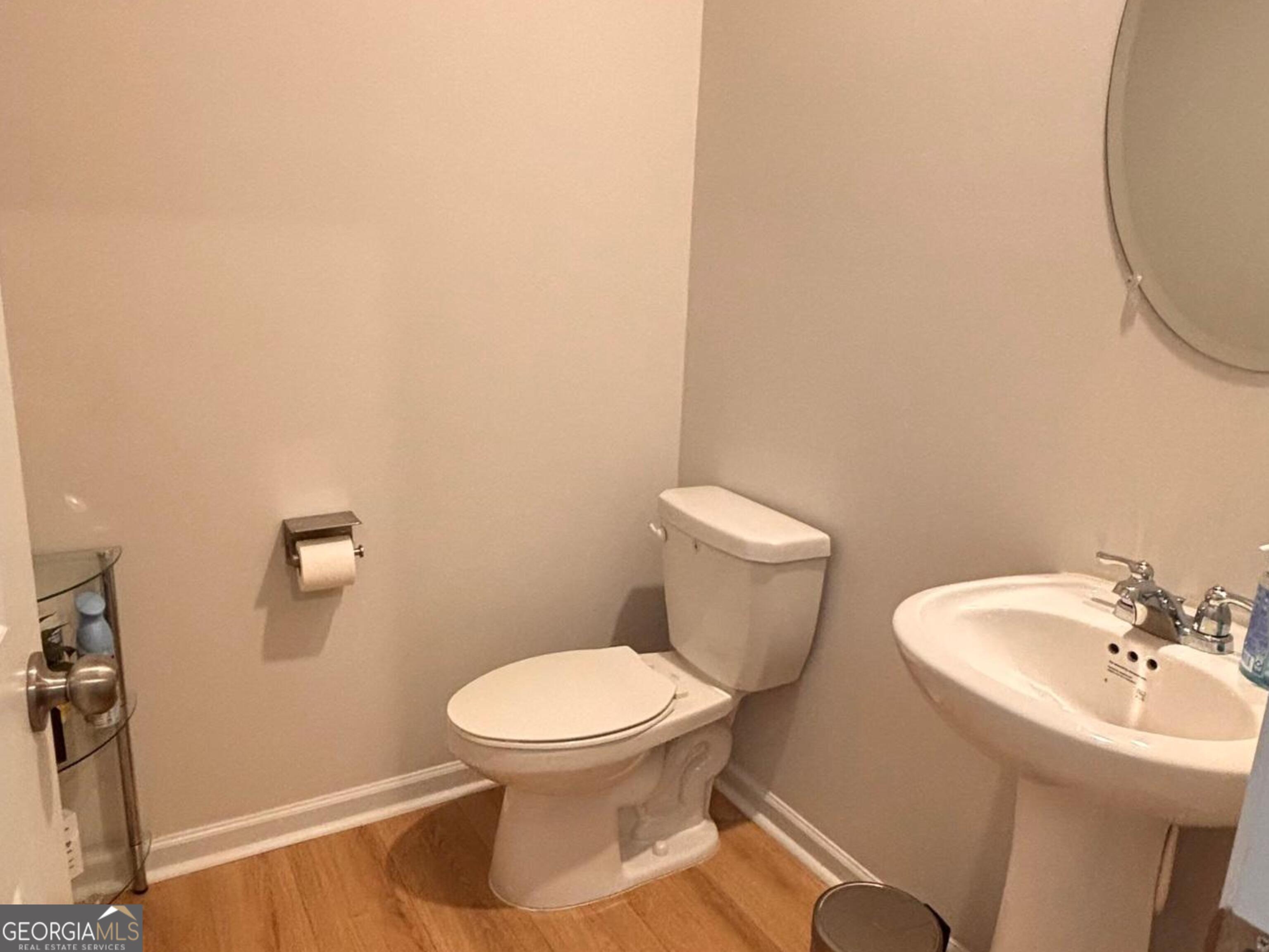 110 Summit Pointe Lane Dallas, GA 30132 - Photo 11 of 25 a white toilet sitting next to a white sink and a mirror