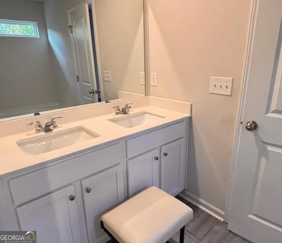 a bathroom with a sink a vanity and a mirror