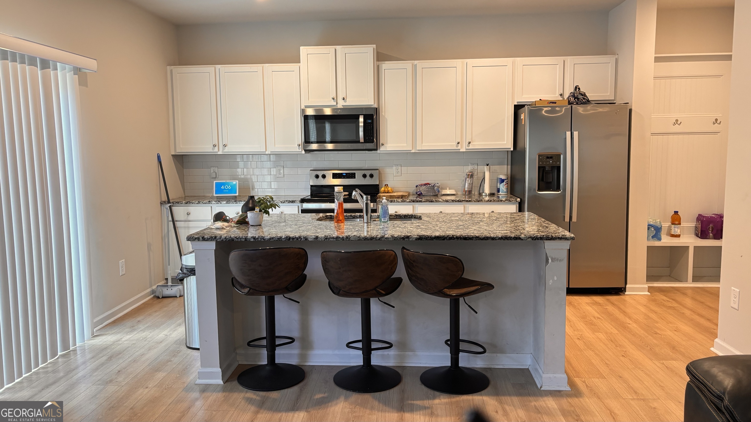 110 Summit Pointe Lane Dallas, GA 30132 - Photo 3 of 25 a kitchen with stainless steel appliances granite countertop a table chairs refrigerator and sink