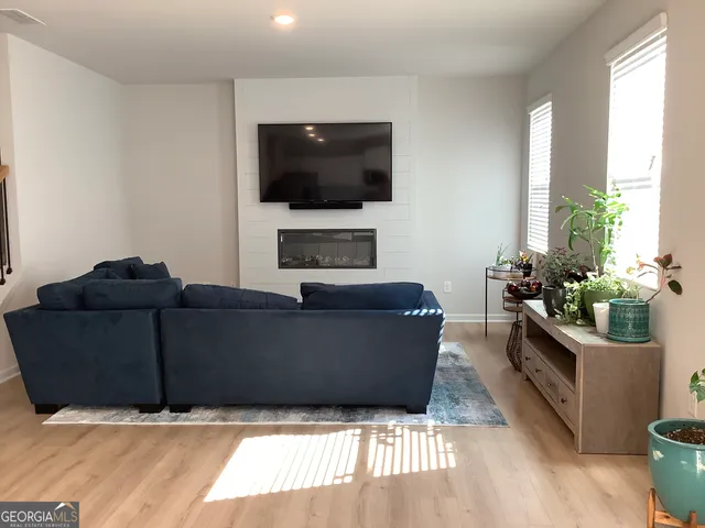 a living room with furniture and a flat screen tv