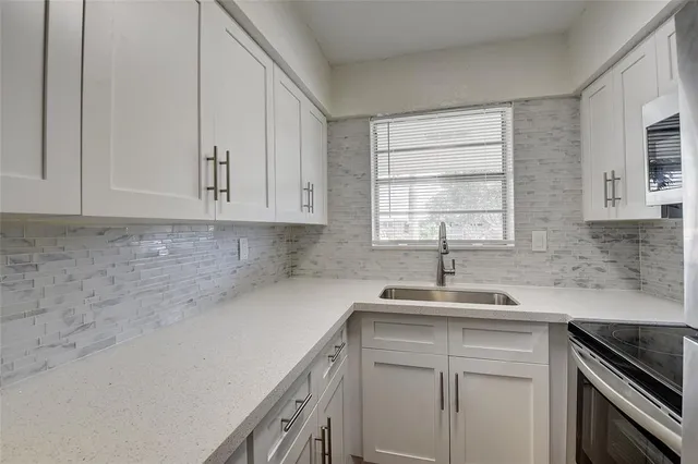 a kitchen with a sink cabinets and window