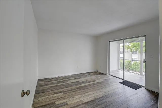 a view of wooden floor and windows in a room