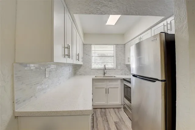 a white refrigerator freezer sitting inside of a kitchen