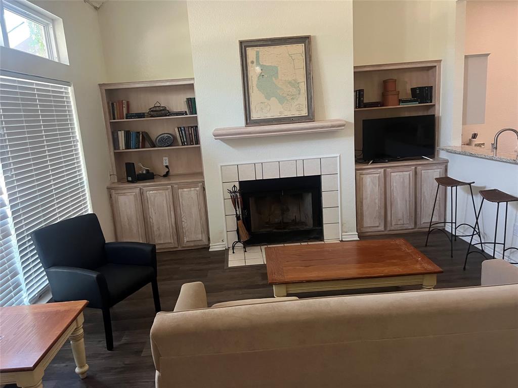 13104 Range Court Whitney, TX 76692 - Photo 2 of 6 a living room with furniture a flat screen tv and a fireplace