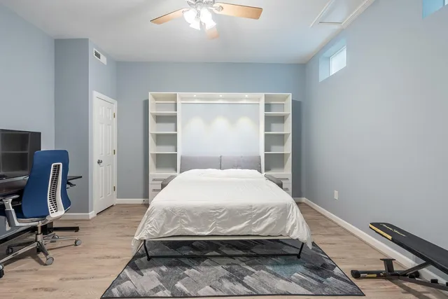 a bed sitting in a room next to a window
