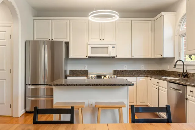 a kitchen with stainless steel appliances granite countertop a refrigerator sink and cabinets