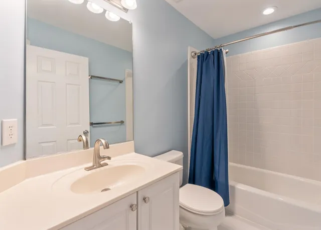 a bathroom with a sink toilet vanity and shower