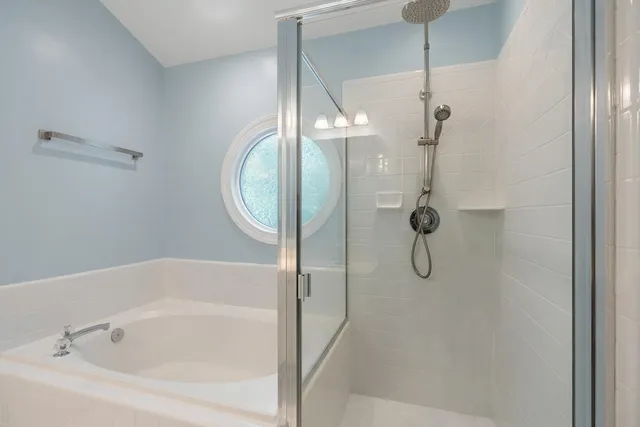 a bathroom with a bathtub and a shower