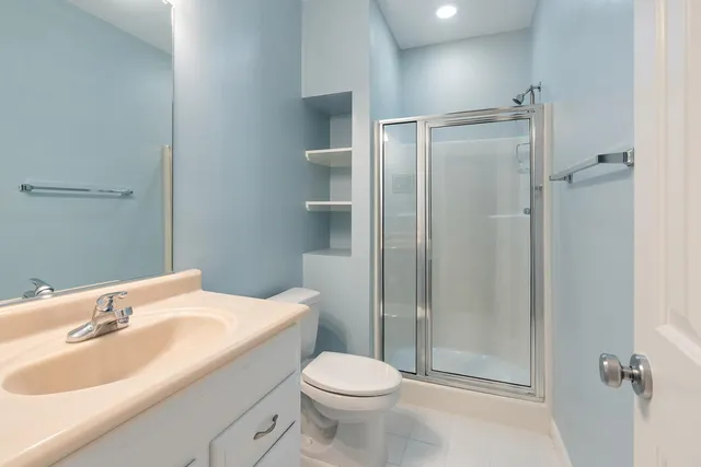 a bathroom with a sink toilet and shower
