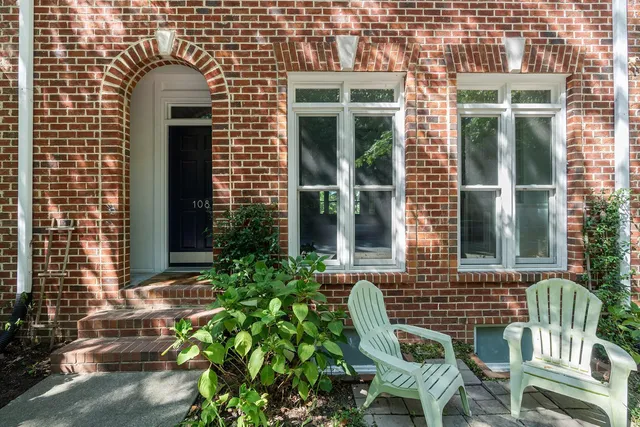 a front view of a house with outdoor seating