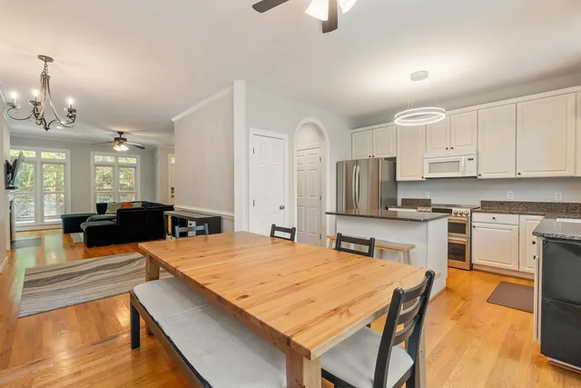 a large kitchen with a table and chairs in it