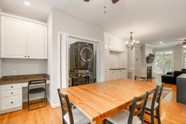 a kitchen with stainless steel appliances kitchen island granite countertop a table and chairs in it