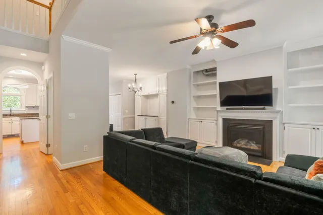 a living room with furniture a fireplace and a flat screen tv