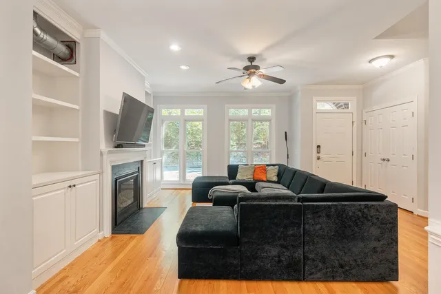 a living room with furniture a fireplace and a flat screen tv