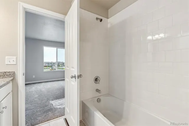 a bathroom with a bathtub and shower