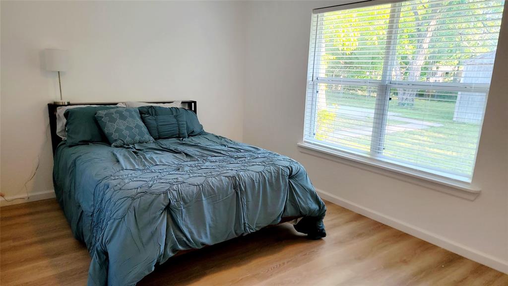 1447 West Lingleville Road Stephenville, TX 76401 - Photo 12 of 12 Bedroom featuring baseboards and wood finished floors